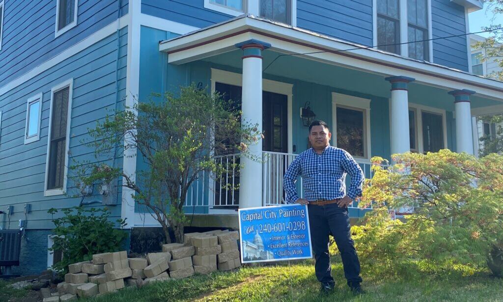 owner in front of a house